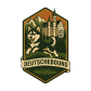 a badge style logo with a small husky-like dog leaping in front of a scene depicting german alps and a german castle